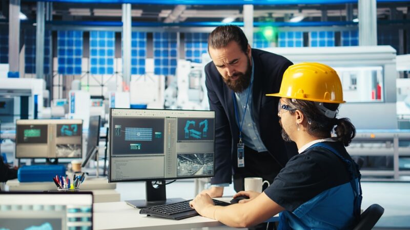 Inženjer i operater analiziraju digitalni prikaz proizvodne linije radi optimizacije i prilagođavanja novim proizvodima